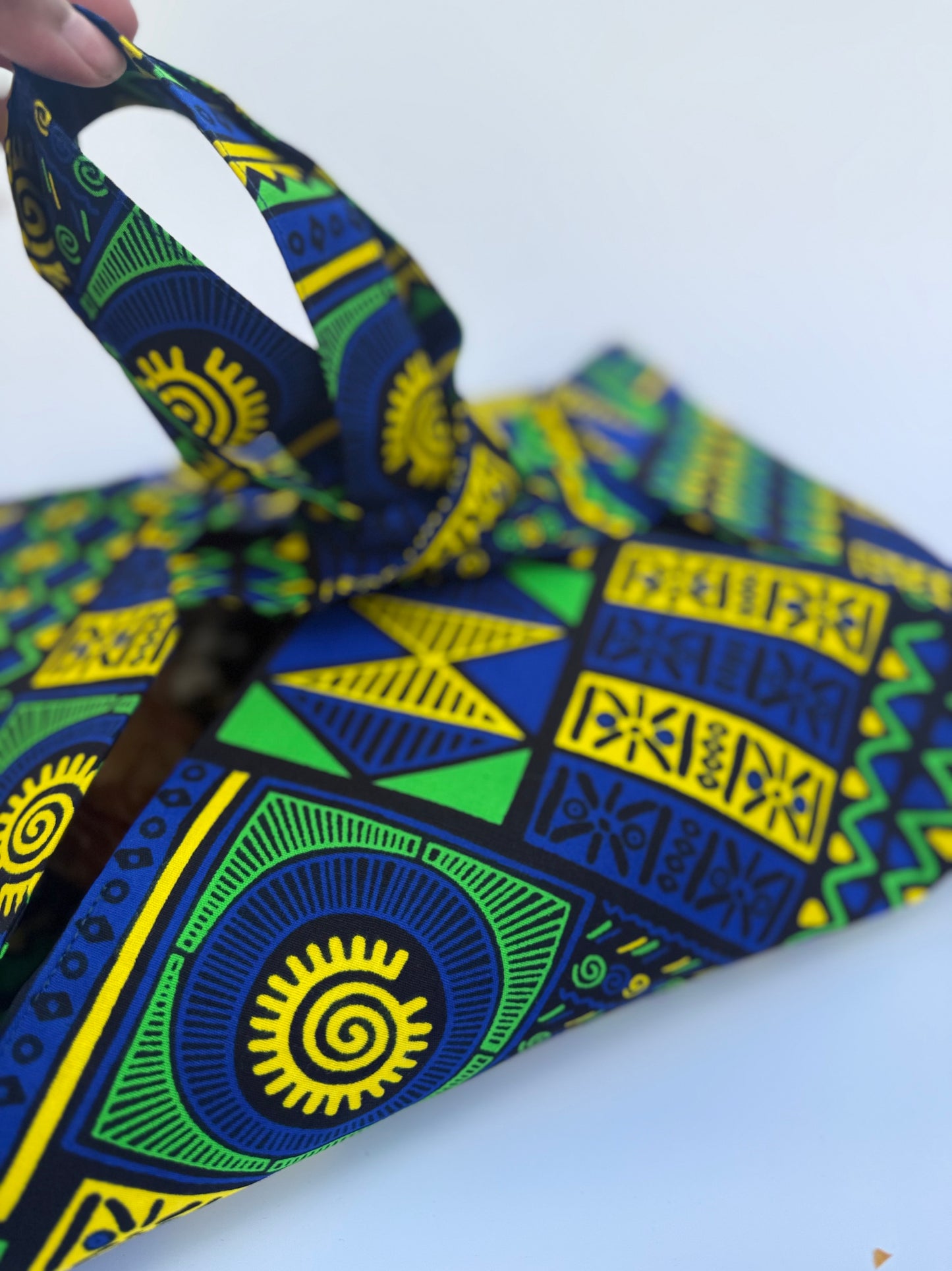 Patterned fabric with blue, green, and yellow colors on a white background