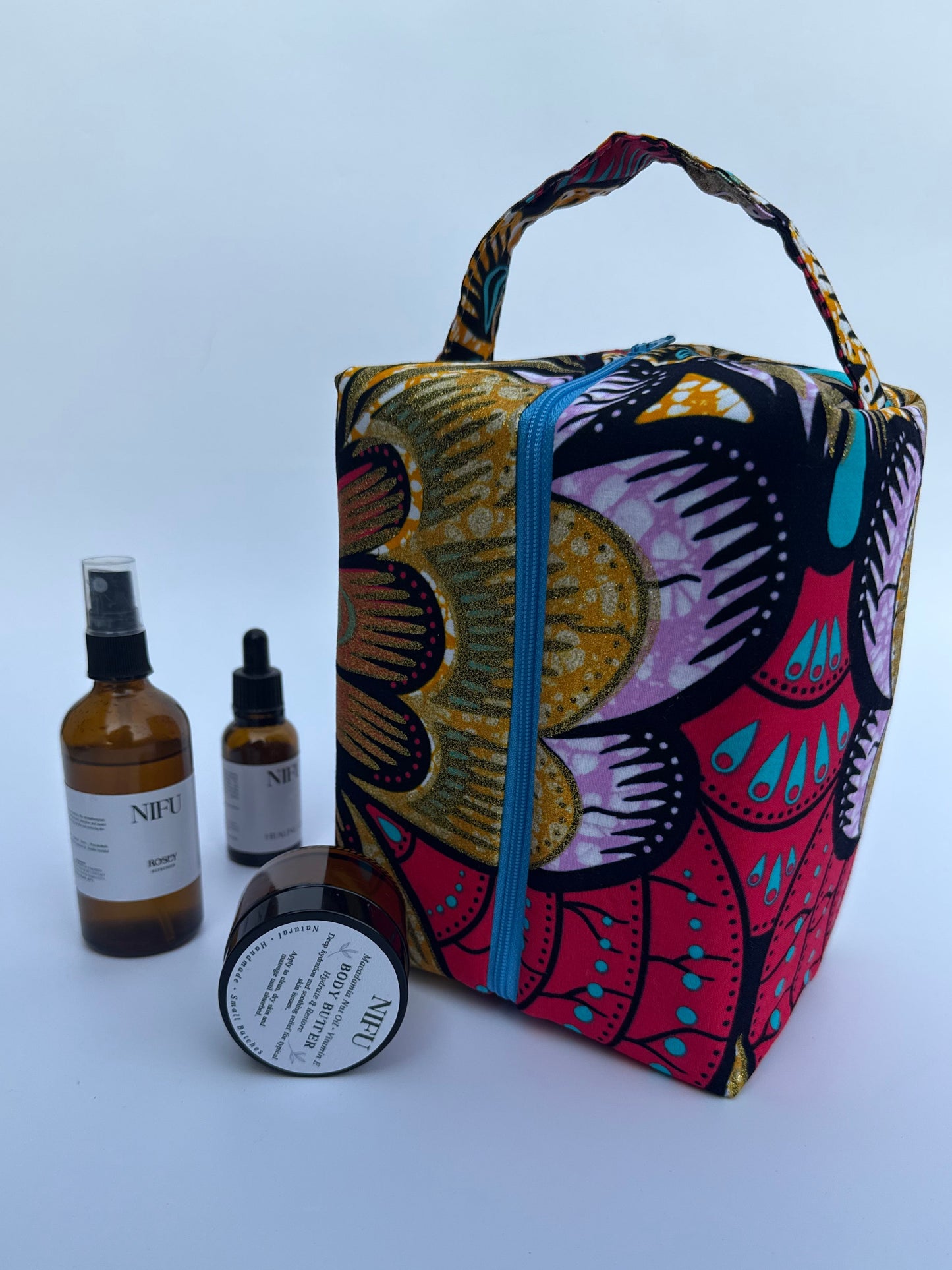 Colorful patterned pouch with skincare products on a white background